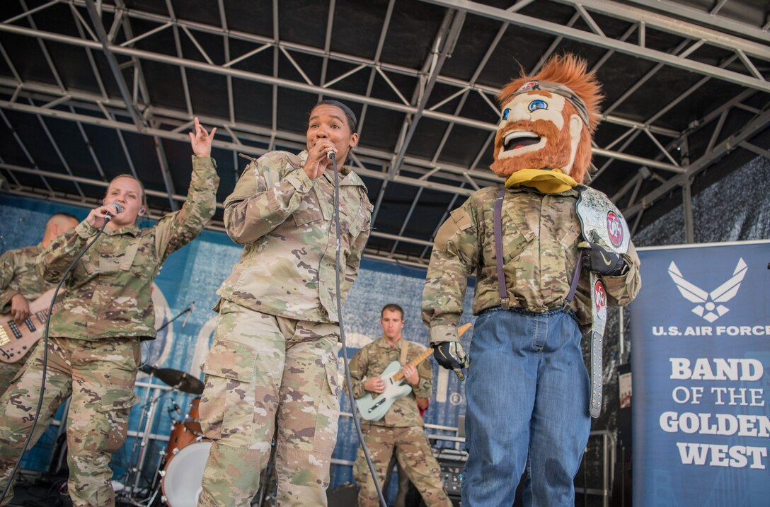 U.S. Air Force Band of the Golden West’s Mobility Rock Band from Travis Air Force Base, California, dances with Sourdough Sam of the San Francisco 49ers