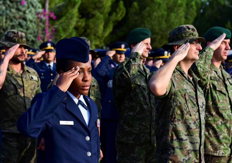 U.S., Turkish, Spanish, Qatari service members from across the base render a salute during the Ataturk Memorial Day Ceremony Nov. 10, 2019, at Incirlik Air Base, Turkey. The ceremony brought members from across the base together to honor Ataturk, the founder and first president of modern Turkey.