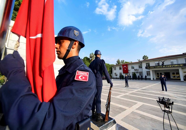 A member of the Turkish air force raises the Turkish flag to half-staff during the Ataturk Memorial Day Ceremony Nov. 10, 2019, at Incirlik Air Base, Turkey. The ceremony commemorated the 81st anniversary of Mustafa Kemal Ataturk’s death. (U.S. Air Force photo by Staff Sgt. Ceaira Tinsley)