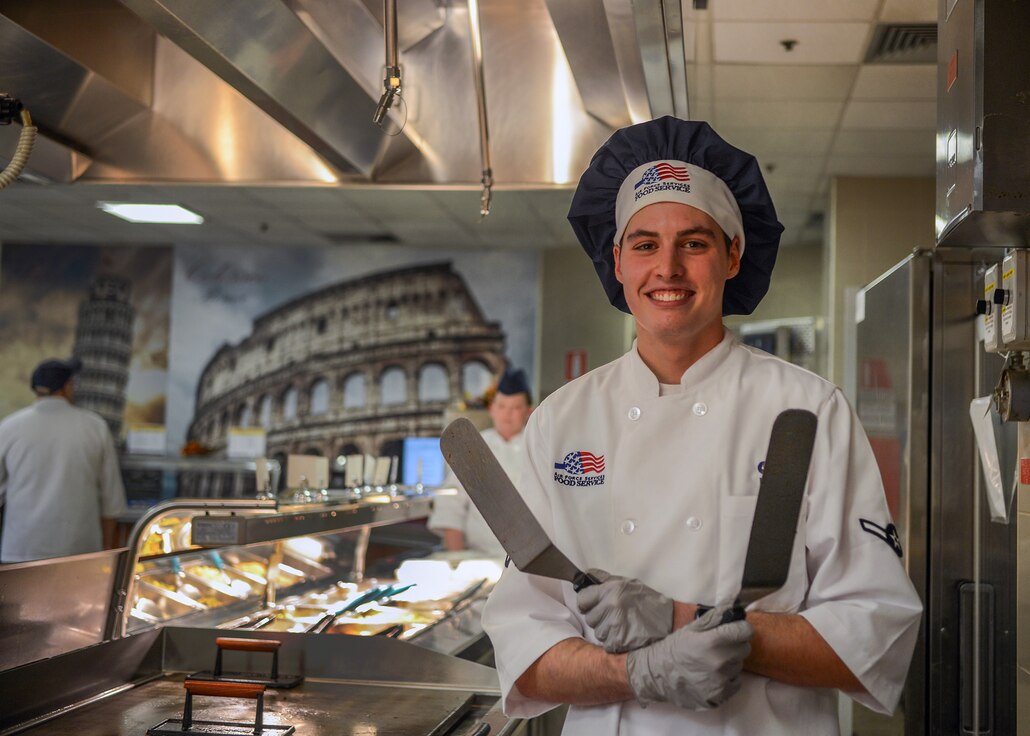 U.S. Airman Kellan S. Hill, 31st Force Support Squadron server, poses for a photo at La Dolce Vita dining facility, Aviano Air Base, Italy, Nov. 7, 2019. Hill works at La Dolce Vita five days every week. (U.S. Air Force photo by Airman Thomas S. Keisler IV)