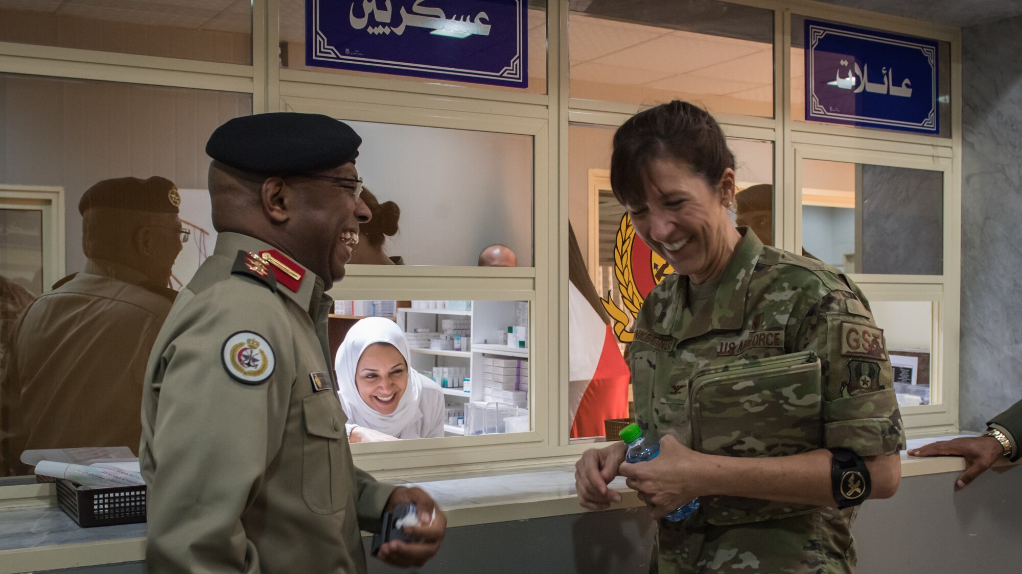 U.S. Air Force Col. Courtney Finkbeiner, right, 386th Expeditionary Medical Group commander, shares a laugh with Kuwaiti army Col. Homoud Alenezi, left, North Military Medical Complex assistant director, and a medical complex staff member in Al Jahra, Kuwait, Nov. 7, 2019. Leadership and staff members from the 386th EMDG visited the hospital to tour the facility and take part in a presentation for a continuiting medical education exchange. (U.S. Air Force photo by Tech. Sgt. Daniel Martinez)