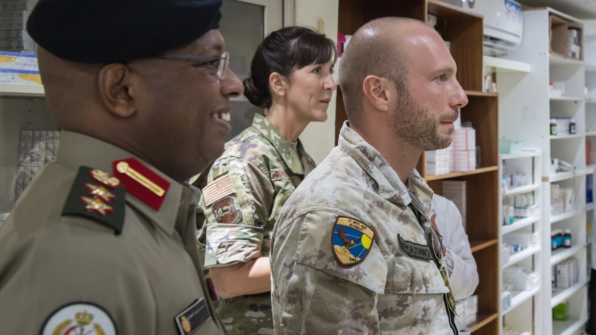 Leadership and staff members from the 386th Expeditionary Medical Group visit the pharmacy at the North Military Medical Complex in Al Jahra, Kuwait, Nov. 7, 2019. Kuwaiti army medics and leadership hosted Airmen from the 386th Expeditionary Medical Group providing a tour of the facility and inviting them to take part in a presentation for a continuiting medical education exchange. Left to right: Kuwaiti army Col. Homoud Alenezi, North Military Medical Complex assistant director; U.S. Air Force Col. Courtney Finkbeiner, 386th EMDG commander; Italian air force Lt. Salvatore Napolitano, Task Force Air-Kuwait flight surgeon. (U.S. Air Force photo by Tech. Sgt. Daniel Martinez)