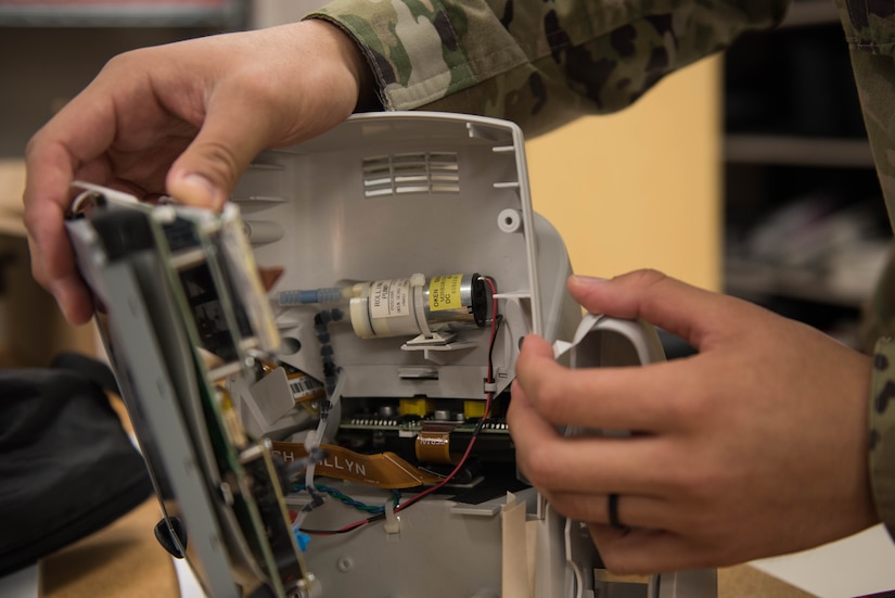 U.S. Air Force Airman 1st Class Timothy Torres, 633rd Medical Group biomedical equipment technician, checks on the motor of a vital signs monitor at Joint Base Langley-Eustis, Virginia, Nov. 8, 2019. BMETs are responsible for routine inspections of equipment throughout Langley Hospital. (U.S. Air Force photo by Airman 1st Class Sarah Dowe)