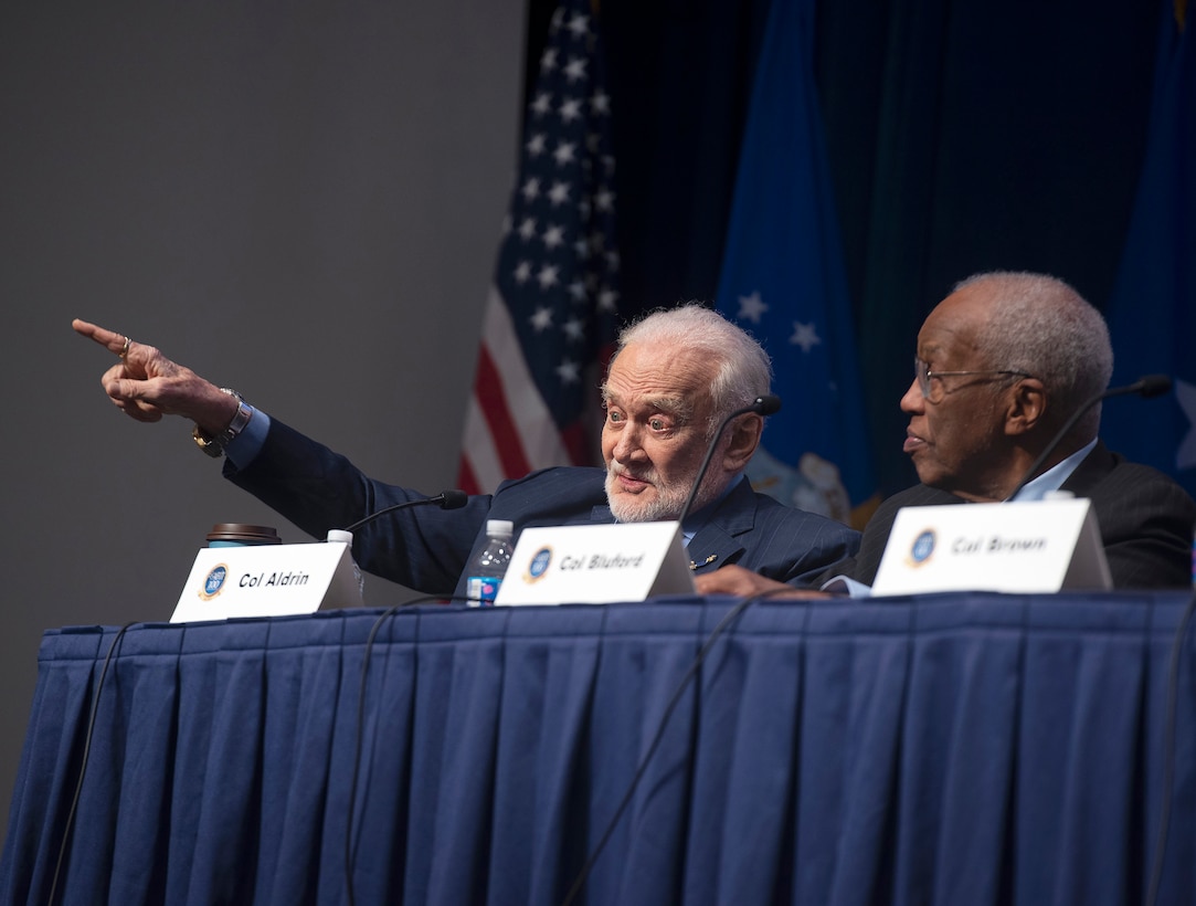 Retired Air Force Col. Buzz Aldrin, the second man to walk on the moon, makes a point during a panel discussion by Air Force Institute of Technology alumni astronauts as part of the AFIT Centennial Symposium on Wright-Patterson Air Force Base, Ohio, Nov. 7, 2019. Retired Col. Guy Bluford, the first African-American in space, also took part in the panel that addressed how AFIT impacted their careers, the future of space and took questions from the audience. (U.S. Air Force photo by R.J. Oriez)