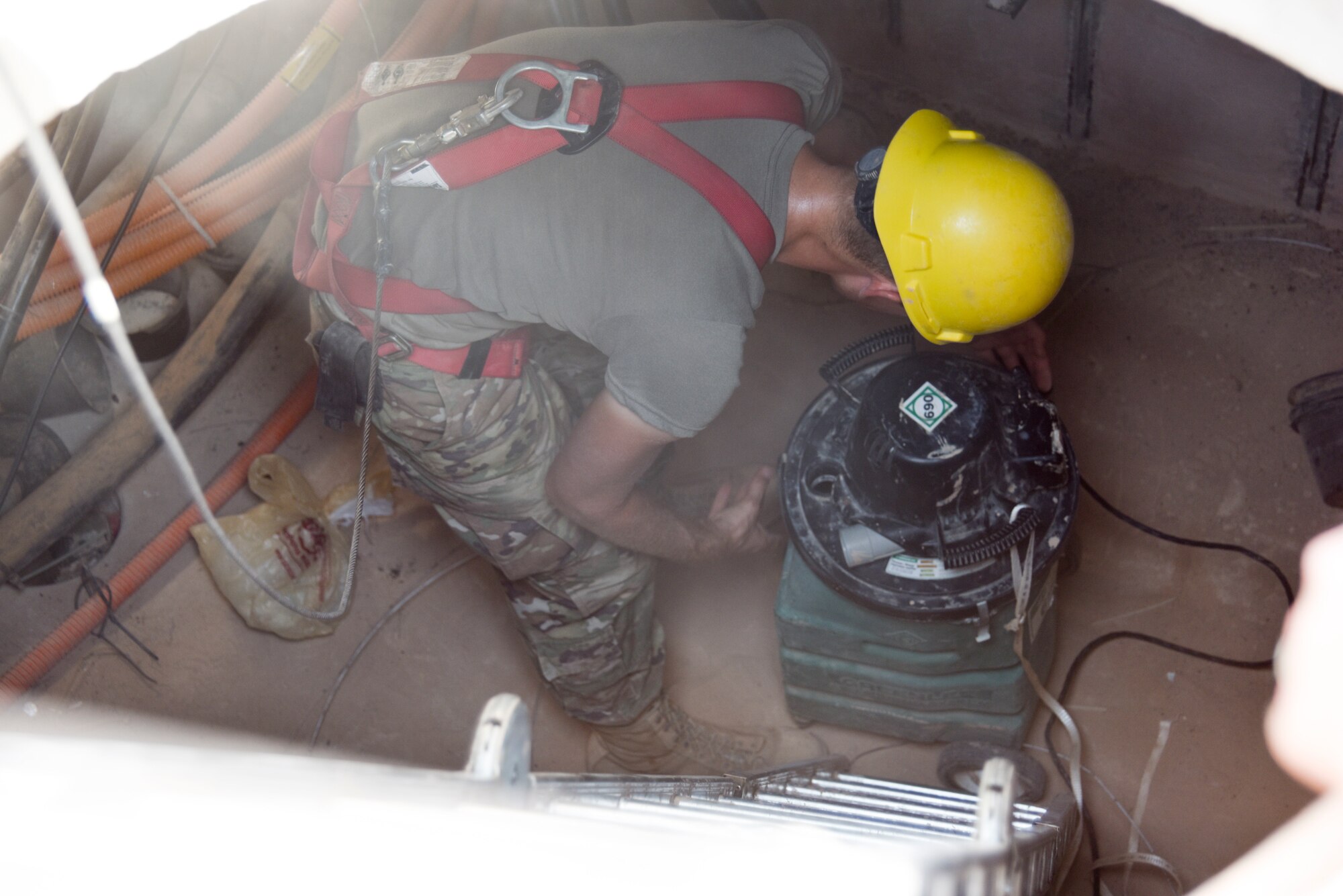 Senior Airman Blase Nyberg, 210th Engineering Installation Squadron cable and antenna systems specialist, cleans up his work area while installing fiber optic cable at Prince Sultan Air Base, Saudi Arabia on Nov. 5, 2019.