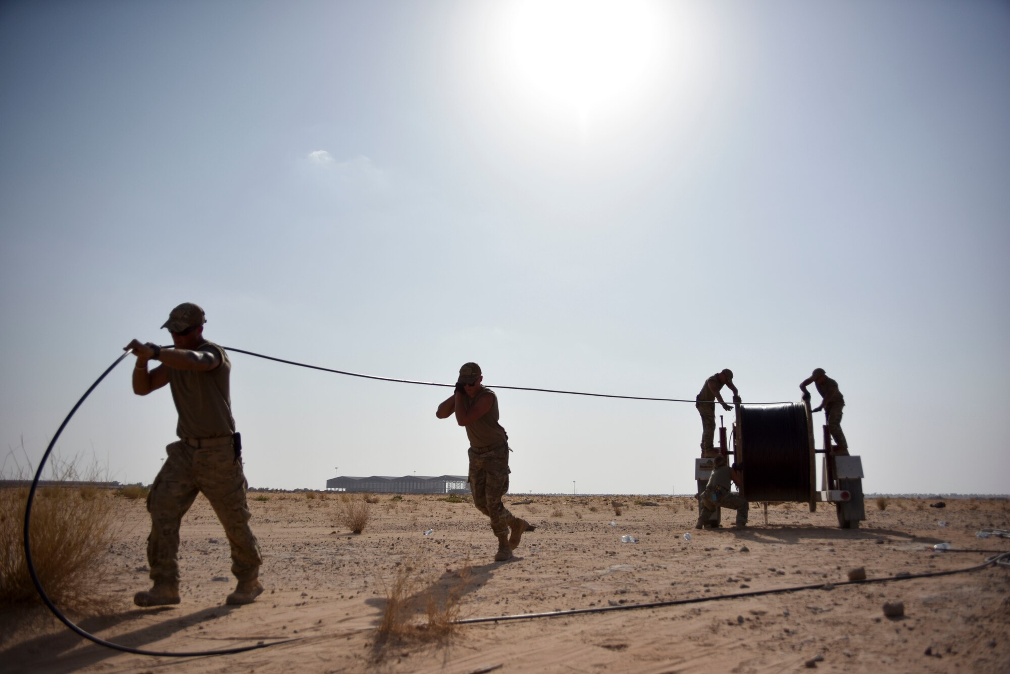 Airmen with the 210th Engineering Installation Squadron measure fiber optic cable prior to running it to the next access point at Prince Sultan Air Base, Saudi Arabia on Nov. 5, 2019.