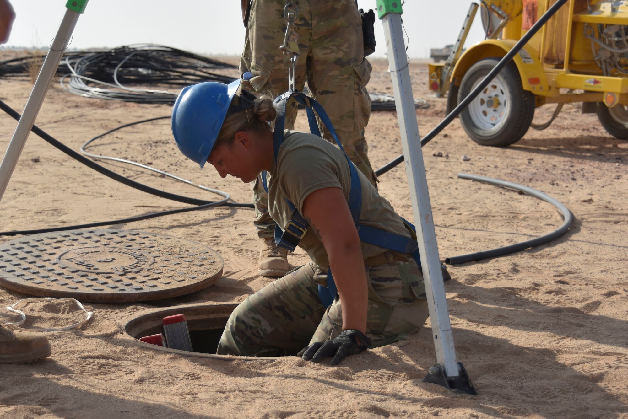 Staff Sgt. Sarah Walz, 210th Engineering Installation Squadron cable and antenna systems specialist, climbs down a ladder to install fiber optic cable at Prince Sultan Air Base, Saudi Arabia on Nov. 5, 2019.