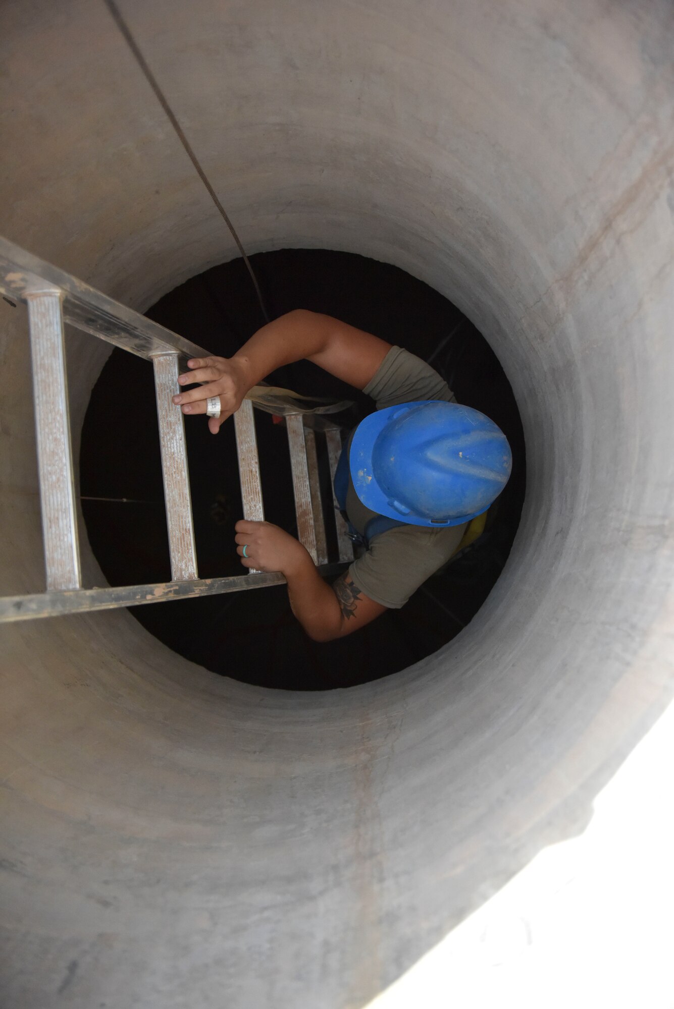 Staff Sgt. Sarah Walz, 210th Engineering Installation Squadron cable and antenna systems specialist, climbs down a ladder to install fiber optic cable at Prince Sultan Air Base, Saudi Arabia on Nov. 5, 2019.