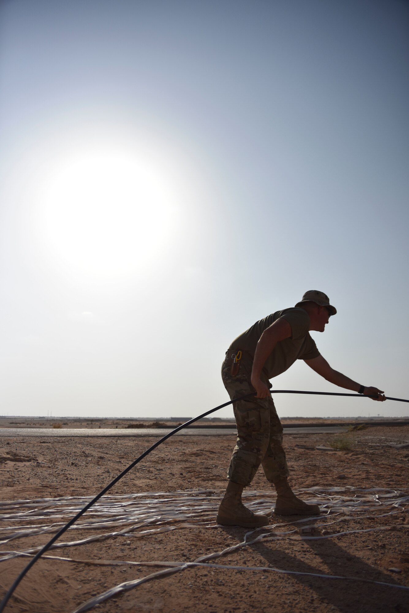 Master Sgt. Drew Gordon, 210th Engineering Installation Squadron cable installation team chief, guides fiber optic cable out of an access point at Prince Sultan Air Base, Saudi Arabia on Nov. 5, 2019.