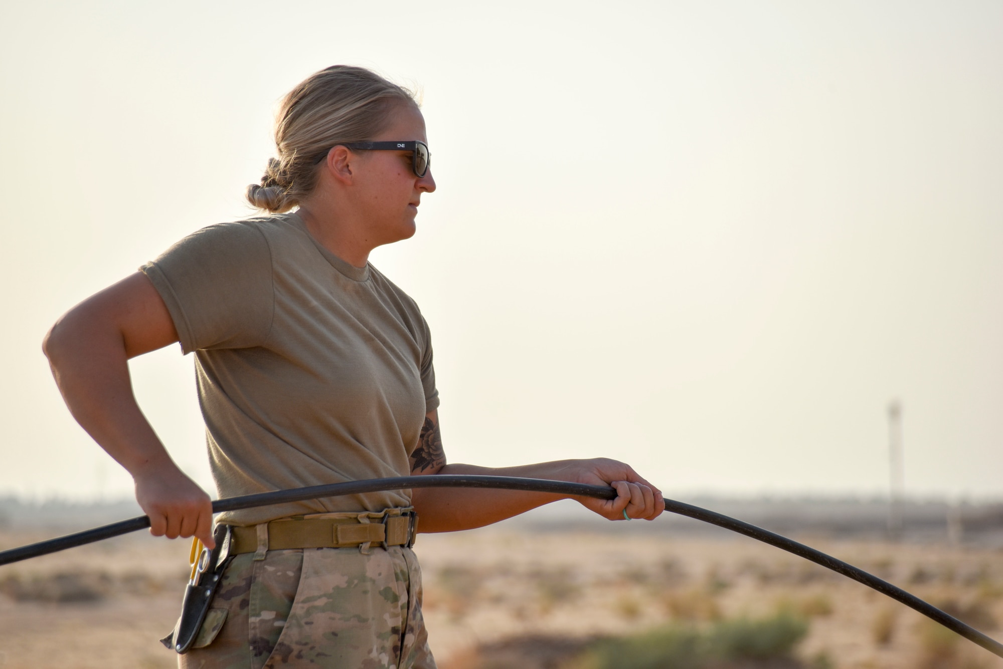 Staff Sgt. Sarah Walz, 210th Engineering Installation Squadron cable and antenna systems specialist, guides optic cable into an access point at Prince Sultan Air Base, Saudi Arabia on Nov. 5, 2019.
