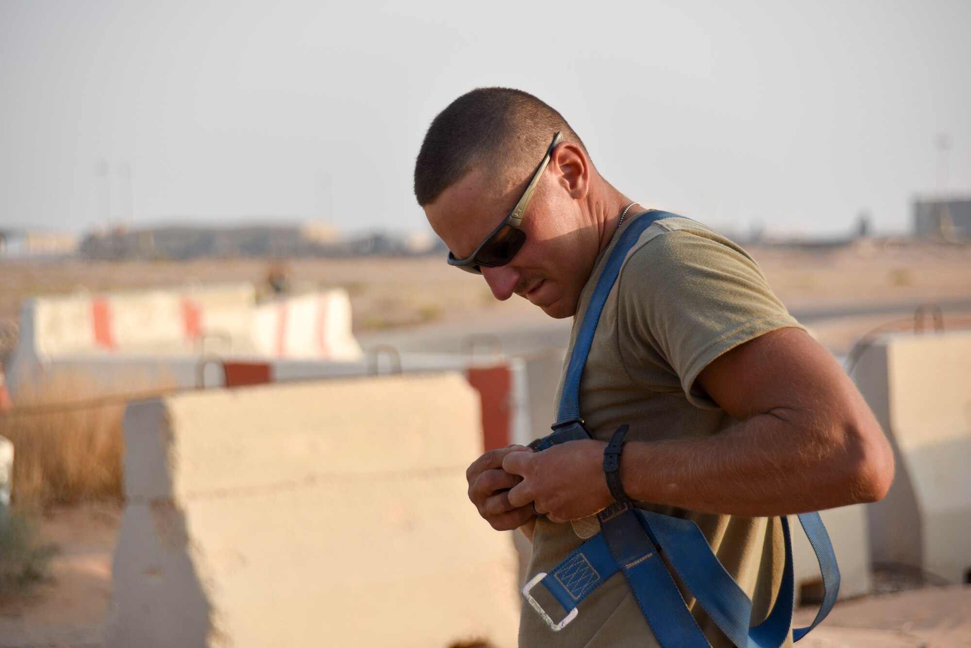 Staff Sgt. Tom Kennedy, 210th Engineering Installation Squadron cable and antenna systems specialist, puts on a safety harness prior to entering a cable access point at Prince Sultan Air Base, Saudi Arabia on Nov. 5, 2019.