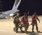 Soldiers offload a simulated casualty from an Air Mobility Command C-17 aircraft after arrival at Joint Base San Antonio-Kelly Airfield as part of a U.S. Army Forces Command Emergency Deployment Readiness Exercise Nov. 4. The exercise tested Brooke Army Medical Center staff’s ability to receive and provide definitive care to wartime trauma victims, as part of its Role IV wartime mission.