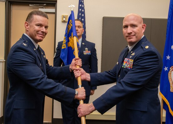 Maj. Brian Bennion assumes command of the 82nd Aerial Port Squadron by accepting the unit guidon from Col. Roderick Grunwald, 349th Mission Support Group commander, during a ceremony Nov. 2, 2019, at Travis Air Force Base, Calif.