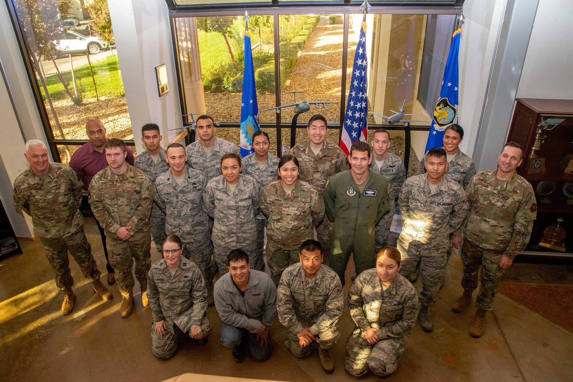 ol. Scott McLaughlin, 349th Air Mobility Wing commander, and Chief Master Sgt. James Burmeister, 349th AMW command chief, pose with the unit's  newest members during the November Unit Training Assembly Nov. 2, 2019, at Travis Air Force Base, Calif.