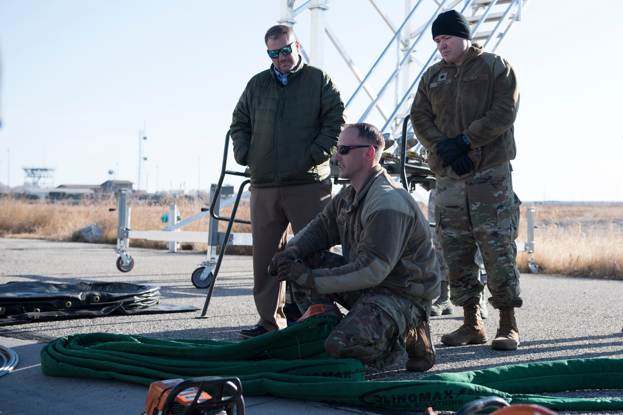 U.S. Air Force Lt. Col. Joshua Payne, 366th Fighter Wing chaplain, and a community representative watch as the crash recovery team shows a demonstration, November 7, 2019, on Mountain Home Air Force Base, Idaho. The crash recovery team is responsible for flightline emergencies. (U.S. Air Force photo by Airman Natalie Rubenak)