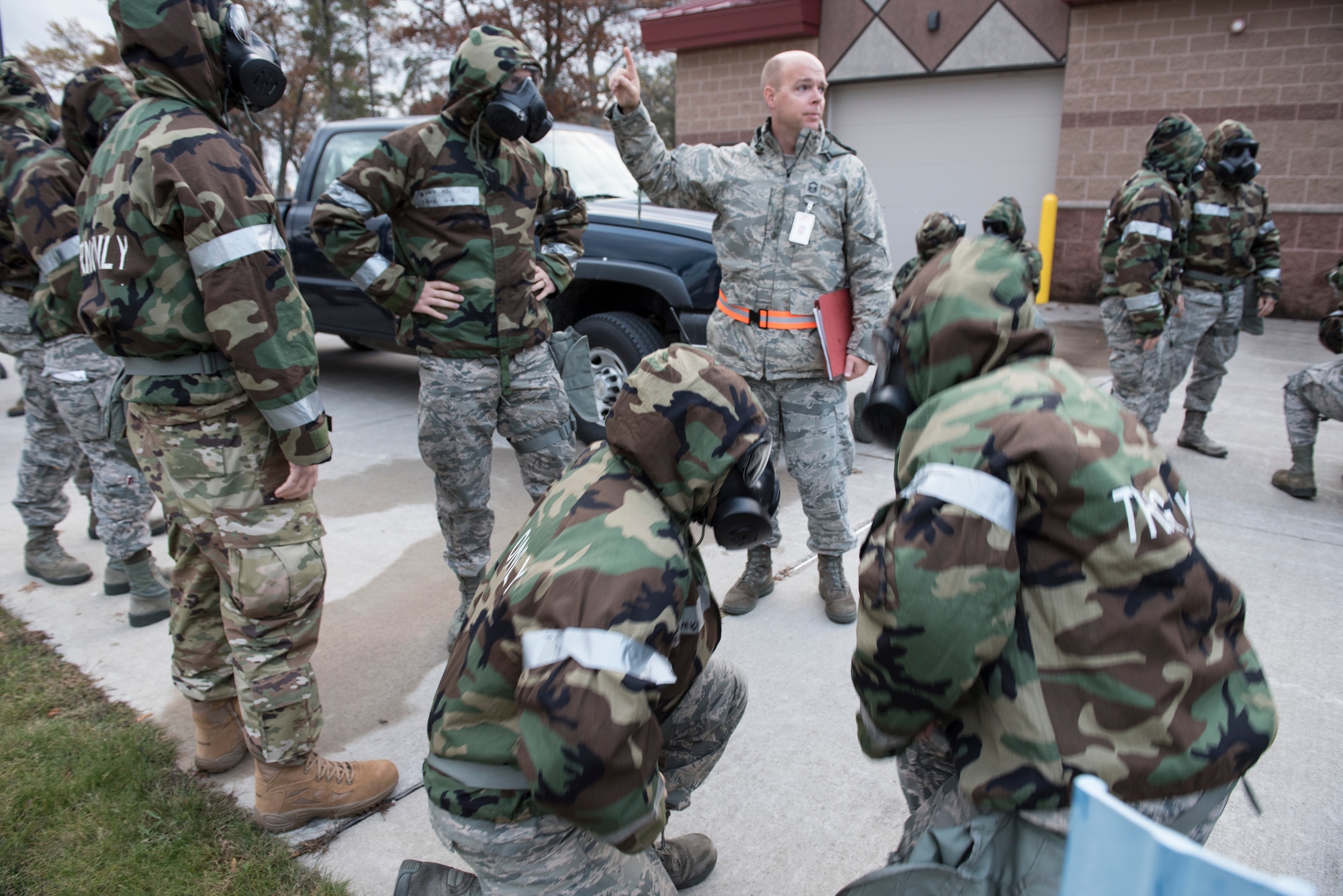 167th Airlift Wing aircraft maintainers run practice donning their gas masks and hoods during a for a full-scale readiness exercise, Nov. 4, 2019. Approximately 300 members of the 167th Airlift Wing deployed to the Combat Readiness Training Center in Alpena, Mich., Nov. 3-7, for the event. (U.S. Air National Guard photo by Senior Master Sgt. Emily Beightol-Deyerle)