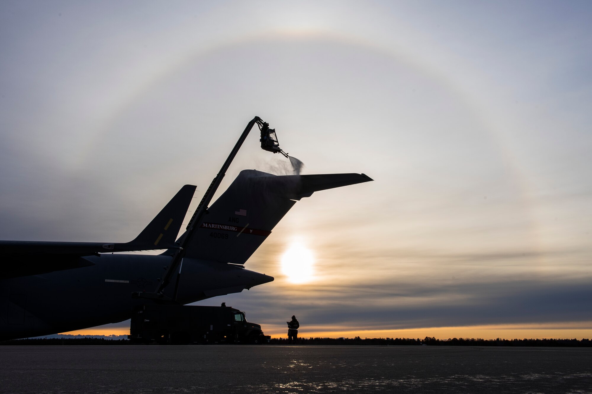 167th Airlift Wing aircraft maintainers sprays de-icing fluid on a C-17 Globemaster III aircraft to prepare it for flight during a full-scale readiness exercise, Nov. 6, 2019. Approximately 300 members of the 167th Airlift Wing deployed to the Combat Readiness Training Center in Alpena, Mich., Nov. 3-7, for the event. (U.S. Air National Guard photo by Senior Master Sgt. Emily Beightol-Deyerle)