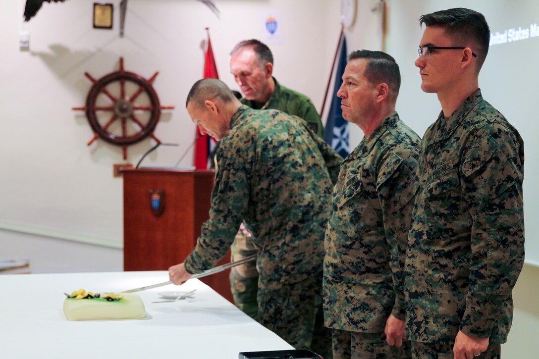 U.S. Marine Corps Maj. Gen. Stephen M. Neary, commanding general, 2nd Marine Expeditionary Brigade, and deputy commanding general, II Marine Expeditionary Force, cuts the ceremonial birthday cake during a ceremony commemorating the 244th U.S. Marine Corps birthday at the Norwegian Joint Headquarters, Reitan, Norway, Nov. 10, 2019.  U.S. Marines and Sailors, service members of the Norwegian Armed Forces, and military members from NATO allies and partners celebrated the U.S. Marine Corps’ warfighting history while sharing military traditions during a short pause in Exercise Trident Jupiter.  The exercise brings together NATO nations to assess their ability to conduct high-end, NATO-level mission planning and execution in a simulated scenario against a peer adversary. (Norwegian Army photo by Mads Bertelsen Reis)