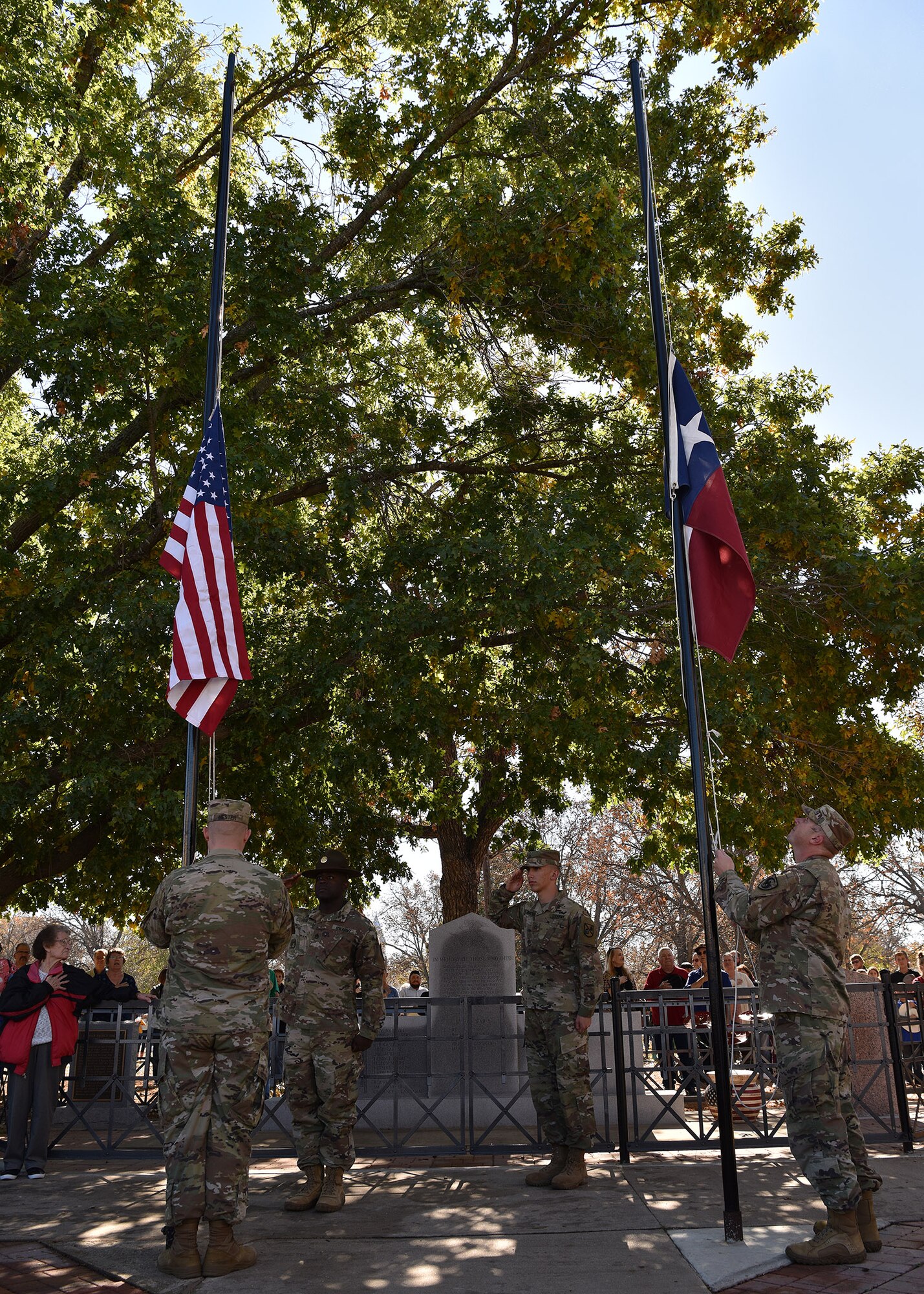 Soldiers assigned to the 344th Military Intelligence Battalion raise the U.S. and Texas state flags during the Veterans Day Parade in Menard, Texas, Nov. 9, 2019. Service members from Goodfellow Air Force Base participated in several local Veterans Day observances, including parades in Menard, Ballinger, and downtown San Angelo. (U.S. Air Force photo by Staff Sgt. Chad Warren/released)