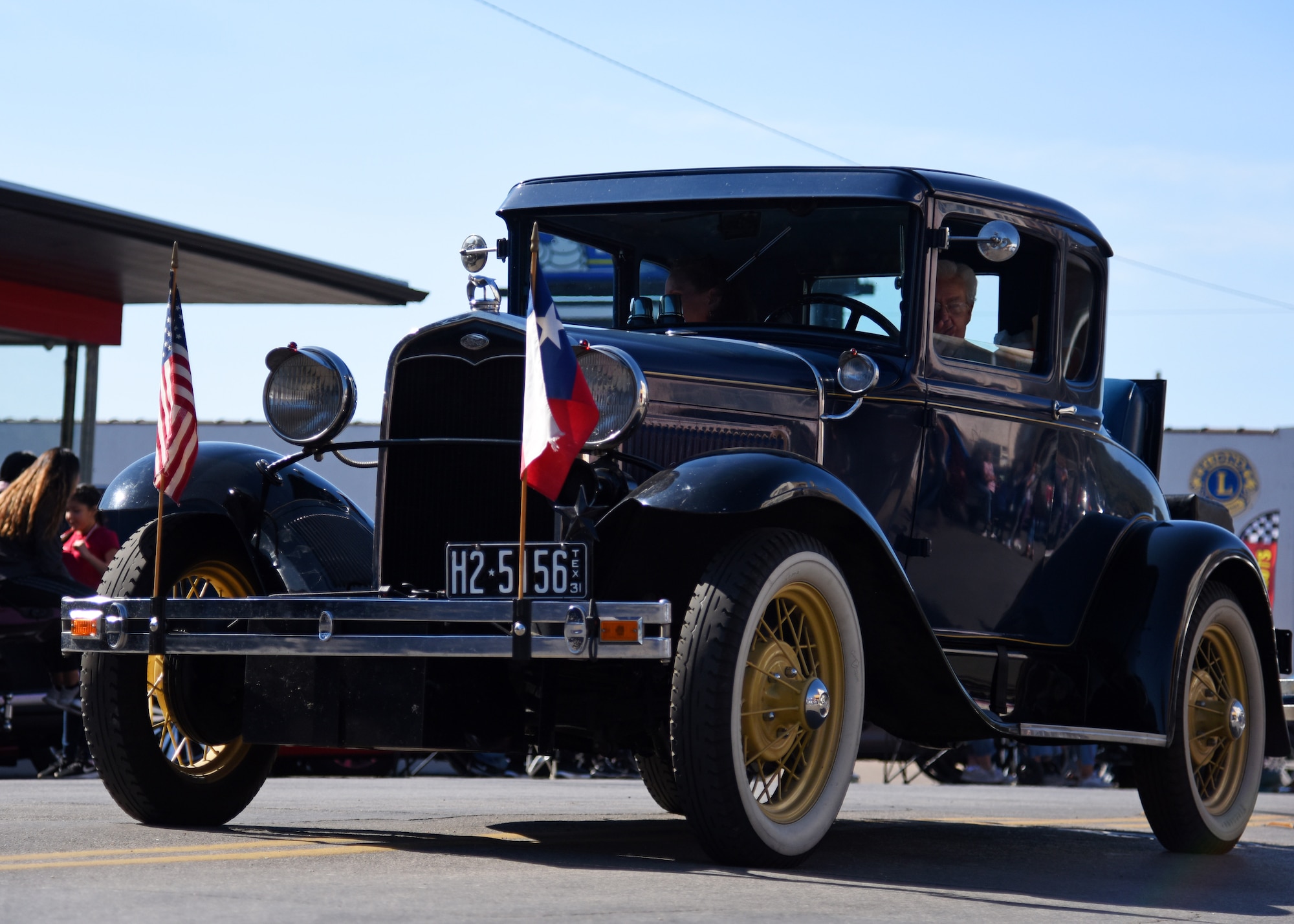 A Ford Model A is driven by a veteran in the Veterans Day Parade in San Angelo, Texas, Nov. 9, 2019. Veterans from several wars, active duty military, supporters of the U.S. military, and others took part in the parade to honor those who have served. (U.S. Air Force photo by Airman 1st Class Ethan Sherwood/Released)