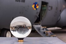 A C130H2 receiving maintenance is viewed through a photographic lens ball at New Castle Air National Guard Base, Del., Oct. 29, 2019. The 166th Aircraft Maintenance Squadron is testing the Conditions Based Maintenance program, which uses predictive analytics to proactively schedule aircraft maintenance. (U.S. Air National Guard photo by Mr. Mitch Topal)