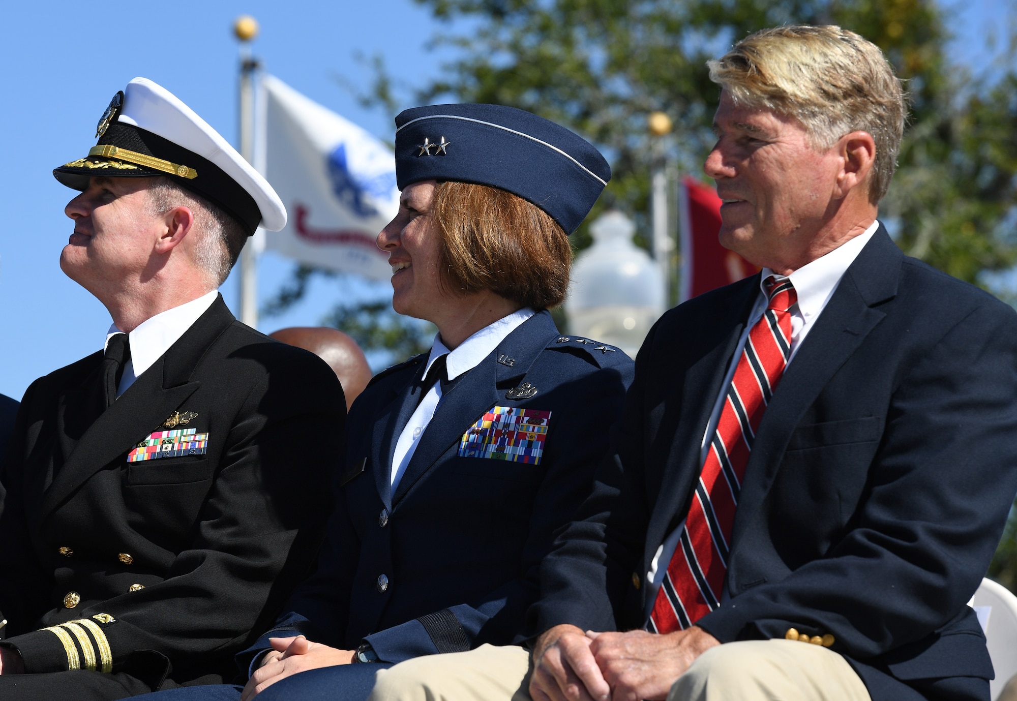 U.S. Air Force Maj. Gen. Andrea Tullos, Second Air Force commander, (center), sits in the reviewing stand with U.S. Navy Commander William Pitcairn IV, Naval Construction Battalion Center executive officer, Gulfport, Mississippi, and Gene Taylor, former U.S. Representative, during the 19th Annual Gulf Coast Veterans Day Parade in DíIberville, Mississippi, Nov. 9, 2019. Keesler Air Force Base leadership, along with hundreds of Airmen, attended and participated in the parade in support of all veterans past and present. More than 70 unique floats, marching bands and military units marched in the largest Veterans Day parade on the Gulf Coast. (U.S. Air Force photo by Kemberly Groue)