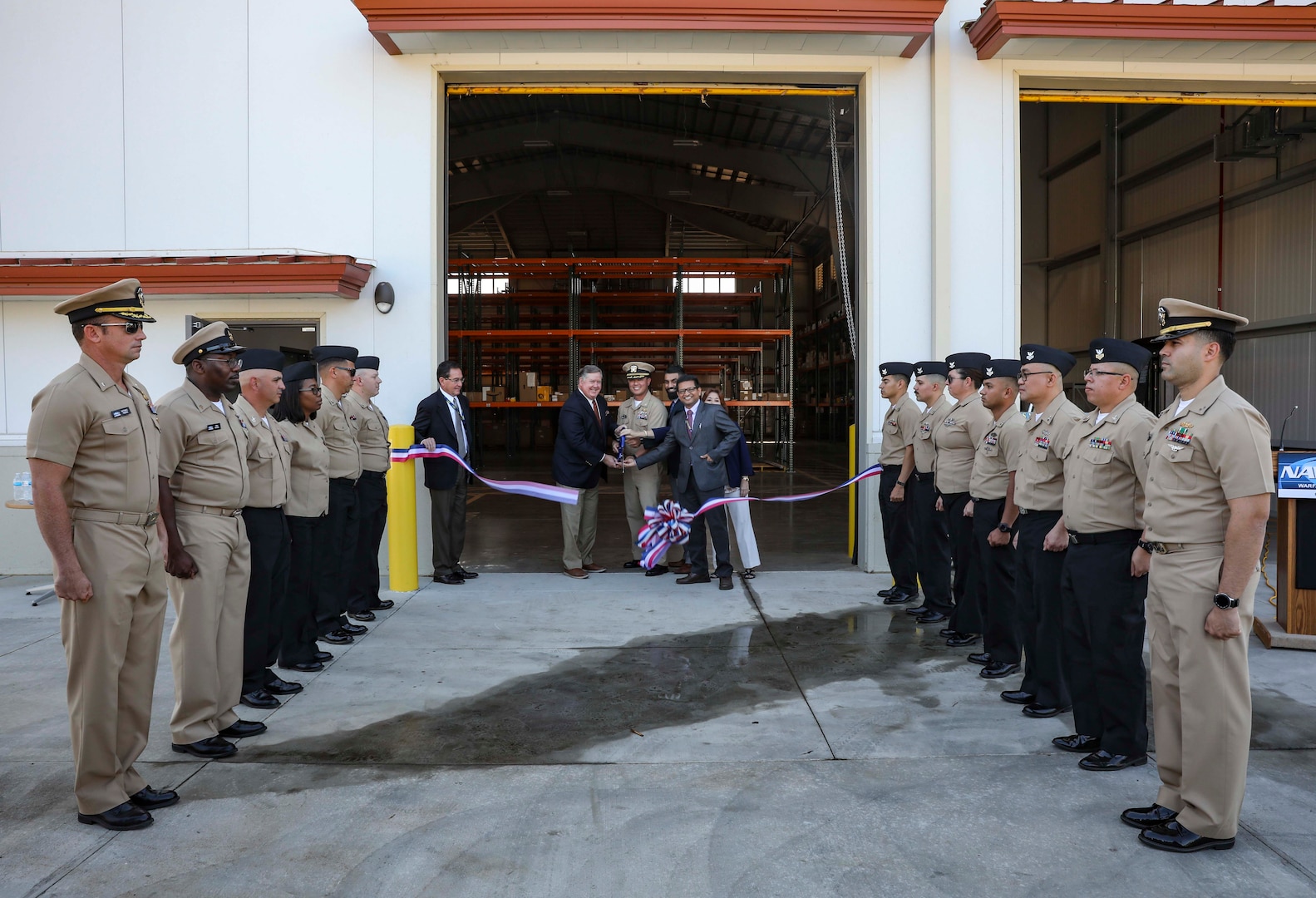 Capt. Khary Hembree-Bey, commanding officer of Naval Surface Warfare Center, Corona Division, (middle), Congressman Ken Calvert (left) and Ashish Patel, Kandeep Sanda and Lesa Jones cut the ribbon at the OM&S Warehouse on Nov. 8.