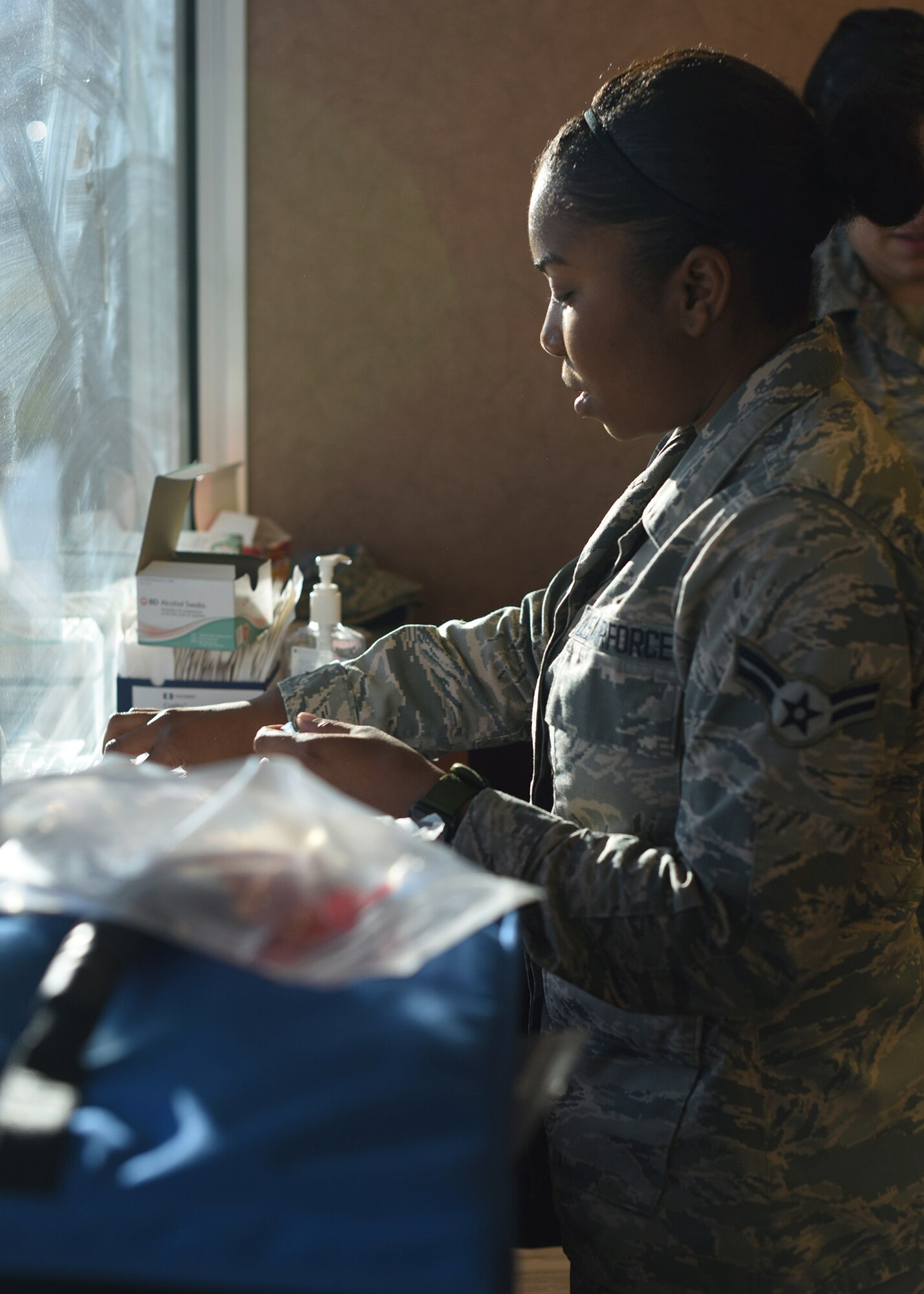 Airman 1st Class Tia N. Johnson, 460th Medical Group medical technician, prepares to administer flu shots during the flu drive at Buckley Air Force Base, Colo., Nov. 5, 2019.