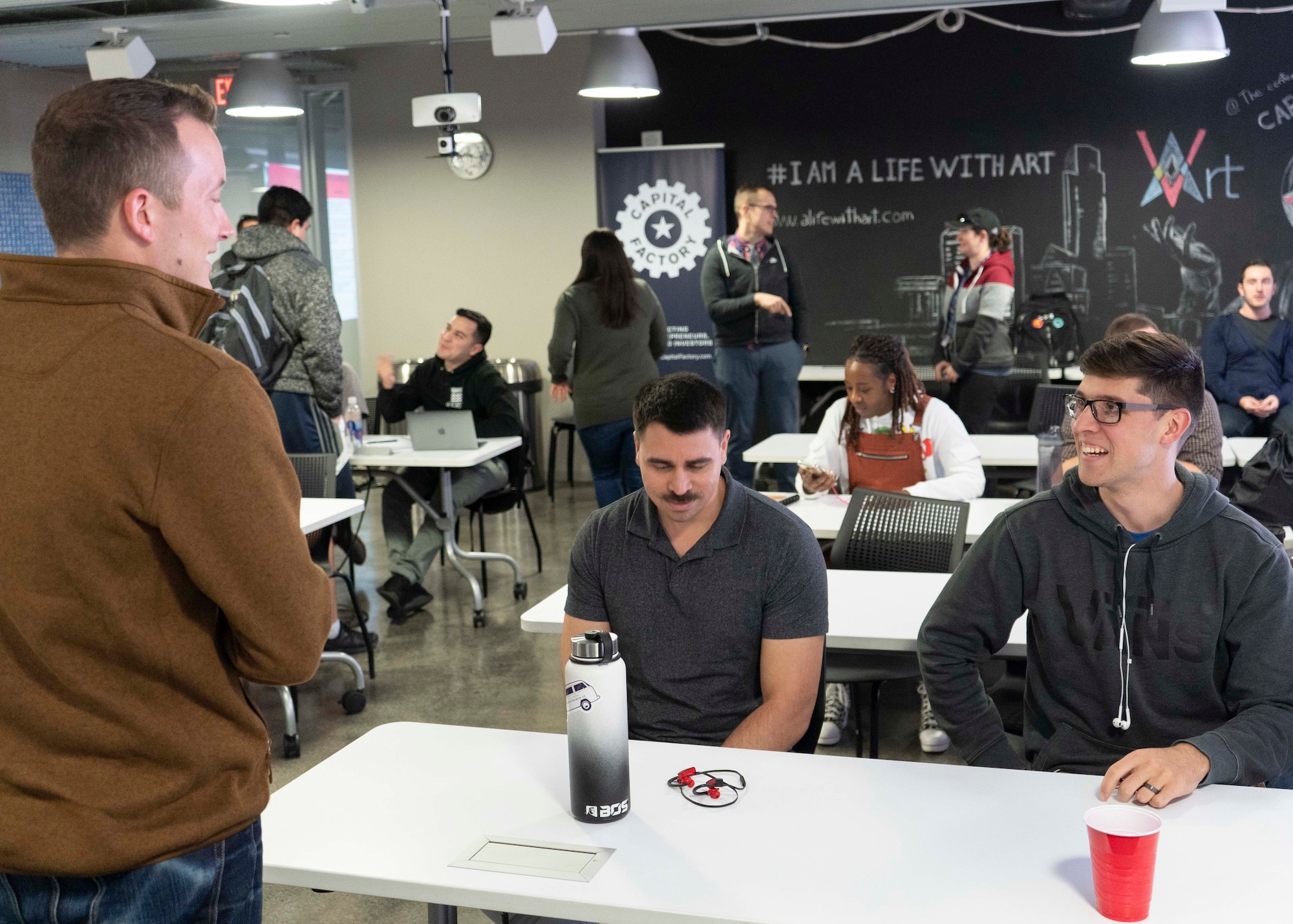 Capt. Kyle Palko, Project NEXUS lead, talks with a few of the course’s students following their final mentorship event of the course at the AFWERX-Austin hub Oct. 16, 2019. Members of the U.S. Air Force’s solution center teams from LevelUP, KesselRun, Space CAMP, and Shadow OC visited the students for a panel discussion on topics like talent management and developing digital competencies within the Air Force. (Air National Guard Photo by Staff Sgt. Jordyn Fetter)