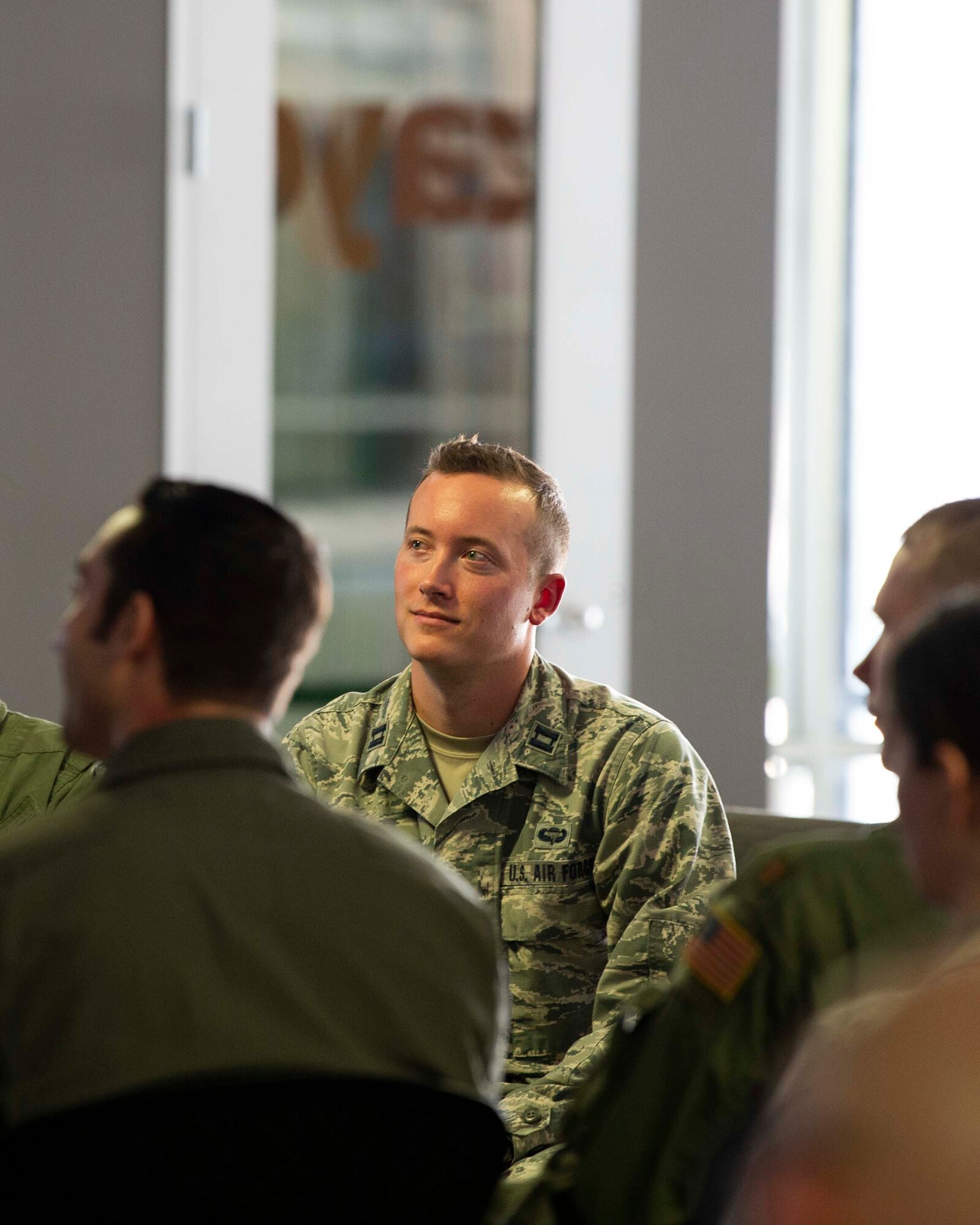 Capt. Kyle Palko, Project NEXUS lead, watches students present their capstone projects during the graduation at the AFWERX-Austin hub, Nov. 11, 2019. Designed by the Air Education and Training Command Technology Integration Detachment, the beta test program was designed to fuel organic technology problem solving efforts for Airmen in their day-to-day workplaces with skills like software development, data science, and user interface/user experience design. (Air National Guard Photo by Staff Sgt. Jordyn Fetter)