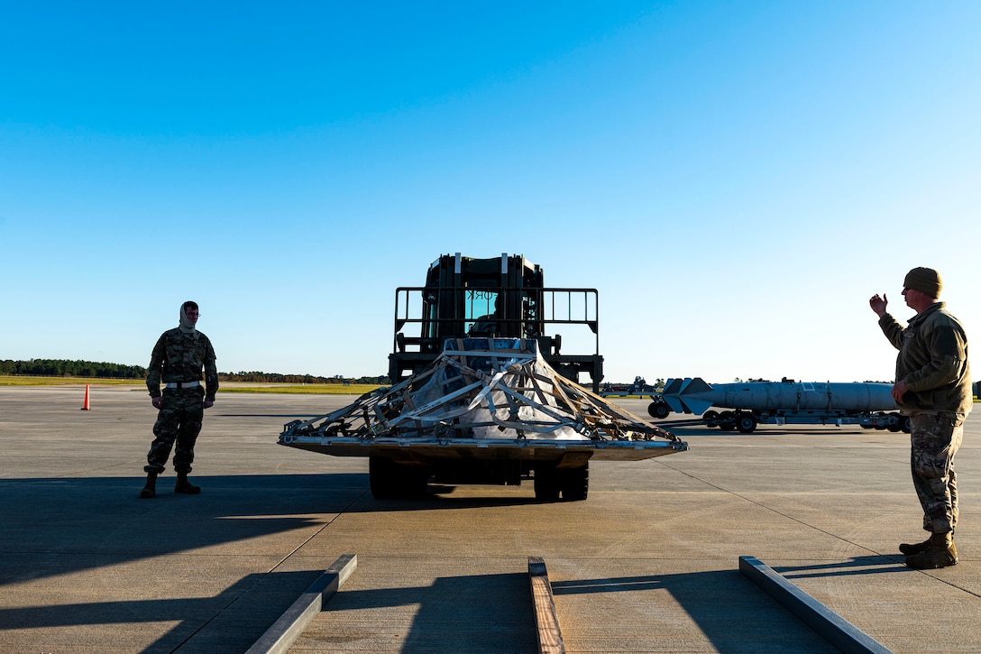 Airmen assigned to the 23d Logistics Readiness Squadron (LRS) marshal equipment through a cargo deployment function during exercise FT 20-01 Nov. 13, 2019, at Moody Air Force Base, Ga. FT 20-01 is a force generation exercise designed to validate the 23d Wing's ability to deploy the 75th Fighter Squadron in support of contingency operations. The 23d LRS conducted a staging area for cargo and equipment where they ensured all resources were properly weighed prior to being loaded onto a simulated aircraft. (U.S. Air Force photo by Senior Airman Erick Requadt)