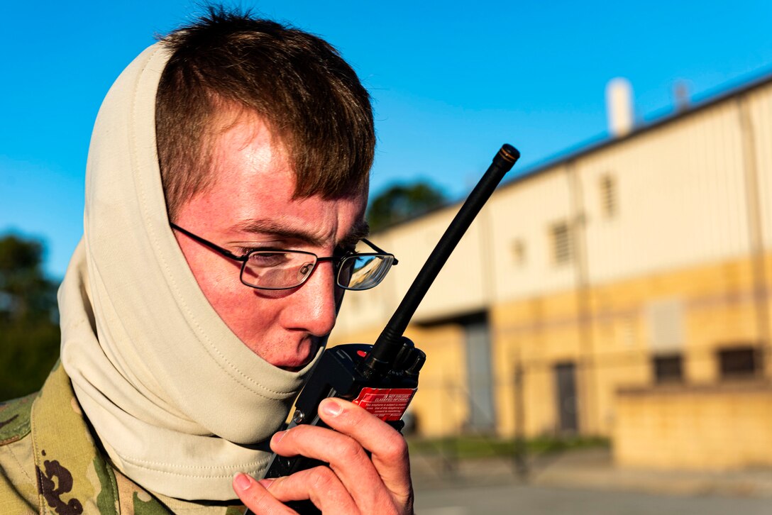 A photo of an Airman using a radio during an exercise