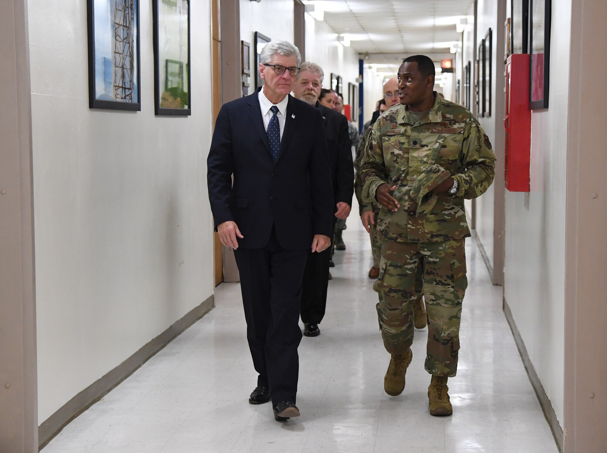 U.S. Air Force Lt. Col. Andre Johnson, 338th Training Squadron commander, escorts Phil Bryant, Governor of Mississippi, to a radio frequency transmission systems course graduation inside Jones Hall at Keesler Air Force Base, Mississippi, Nov. 8, 2019. Bryant presented certificates to the nine course graduates during the ceremony. (U.S. Air Force photo by Kemberly Groue)