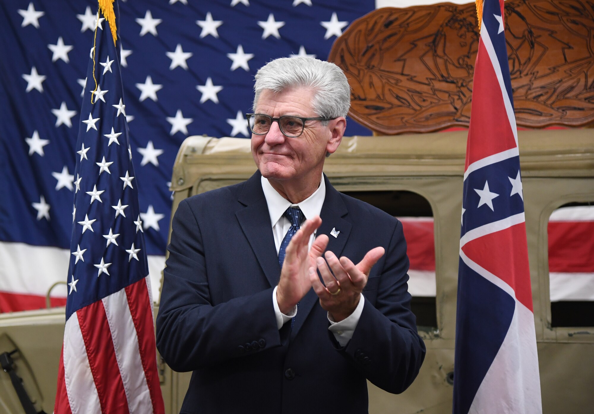 Phil Bryant, Governor of Mississippi, claps for graduates during the 338th Training Squadron radio frequency transmission systems course graduation inside Jones Hall at Keesler Air Force Base, Mississippi, Nov. 8, 2019. Bryant presented certificates to the nine course graduates during the ceremony. (U.S. Air Force photo by Kemberly Groue)