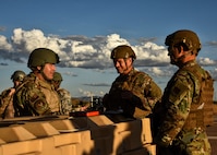 A photo of airmen standing around a crate during an exercise.