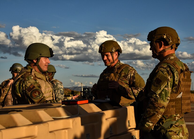 U.S. Air Force Col. Michael Drowley, 355th Wing commander, and Chief Master Sgt. James Lyda, 355th Wing command chief, talk to Brig. Gen. Chad Raduege, Director of Cyberspace and Information Dominance, and Chief Information Officer at Headquarters Air Combat Command, during Exercise Bushwhacker 19-08 at Libby Army Airfield, Arizona, Nov. 5, 2019. Bushwhacker 19-08 included support from outside of the wing to include F-15E Strike Eagles from Mountain Home Air Force Base, Idaho, and the 5th Combat Communications Group from Robins AFB, Georgia. (U.S. Air Force photo by 2nd Lt. Casey E. Bell)