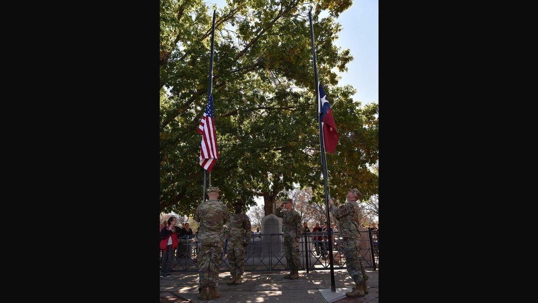 Soldiers assigned to the 344th Military Intelligence Battalion raise the U.S. and Texas state flags during the Veterans Day Parade in Menard, Texas, Nov. 9, 2019. Service members from Goodfellow Air Force Base participated in several local Veterans Day observances, including parades in Menard, Ballinger, and downtown San Angelo. (U.S. Air Force photo by Staff Sgt. Chad Warren/released)