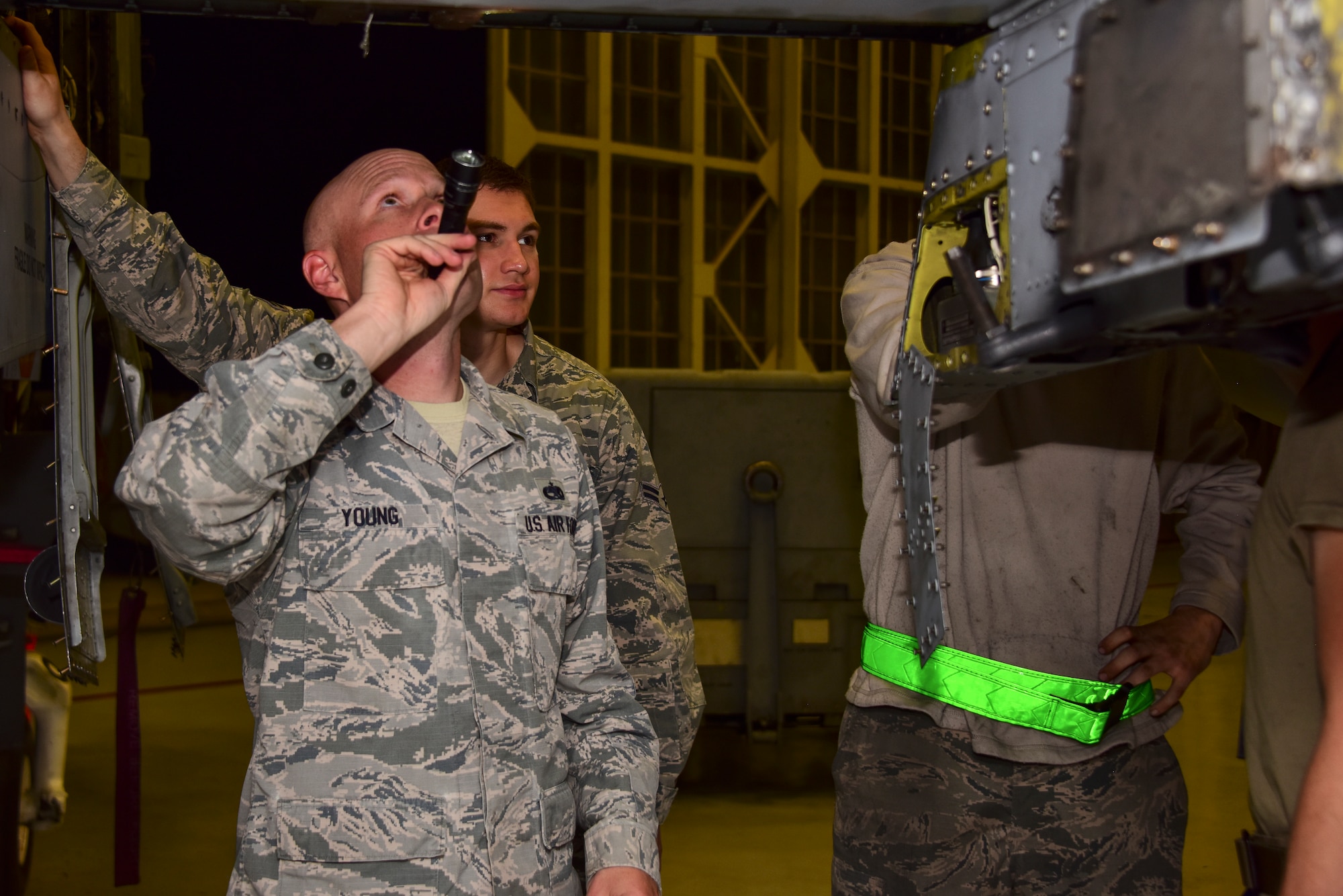 A photo of airmen working on an A-10.