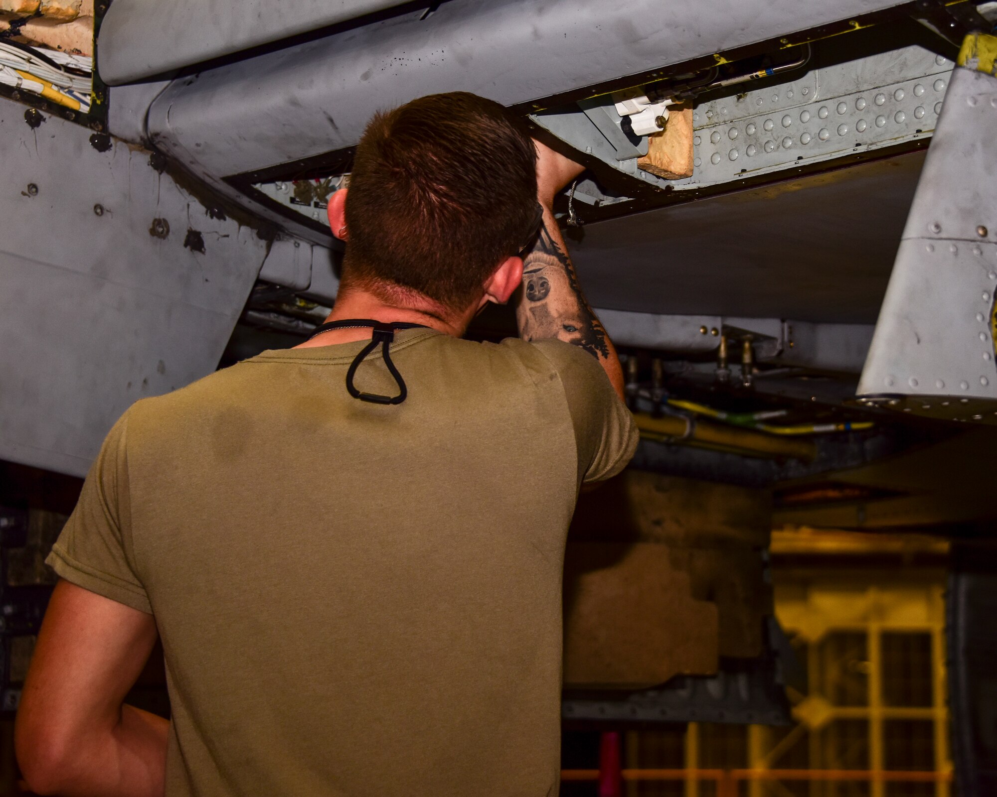 A photo of an airman working on an A-10.