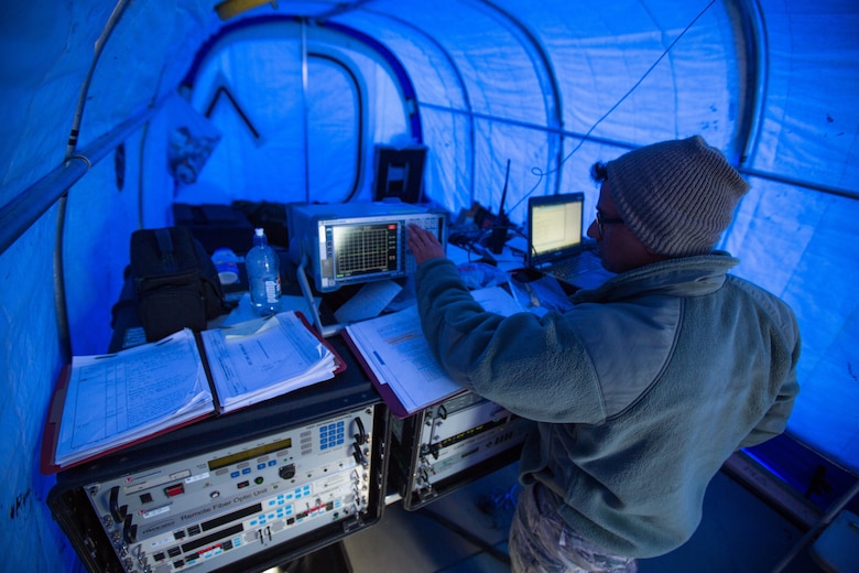 U.S. Air Force Staff Sgt. Titus Poulose of the 263rd Combat Communications Squadron with the North Carolina Air National Guard, operates communications equipment inside of a special cold-weather tent while deployed in support of Operation Deep Freeze (ODF), at McMurdo Station, Antarctica, Dec. 6, 2018. ODF is a military mission in support of the National Science Foundation throughout the continent of Antarctica, to provide air, land, and sea support to McMurdo Station. (Courtesy photo submitted by Civ. Johnny Chiang)