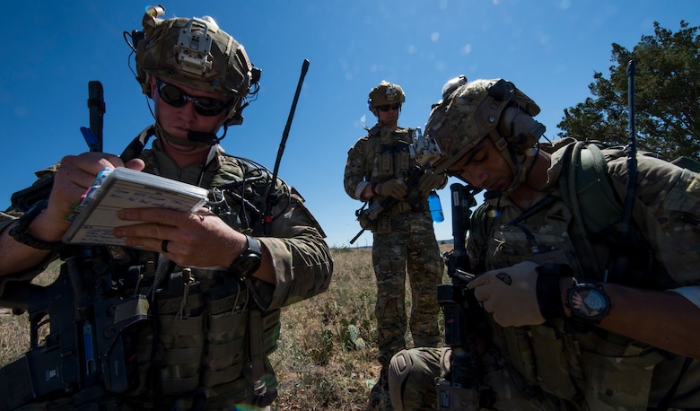 U.S. Air Force Tactical Air Control Party (TACP) Airmen from the 13th Air Support Operations Squadron, communicate to a simulated pilot during a field training exercise near Fort Carson, Colo., July 15, 2019. The exercise tested the TACP Airmen on how to navigate through deployment-like terrain, perform reconnaissance and intelligence on an enemy and close-quarters weapons training. (U.S. Air Force photo by Staff Sgt. Matthew Lotz)