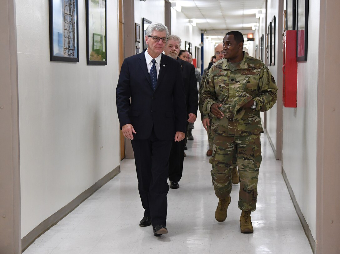 U.S. Air Force Lt. Col. Andre Johnson, 338th Training Squadron commander, escorts Phil Bryant, Governor of Mississippi, to a radio frequency transmission systems course graduation inside Jones Hall at Keesler Air Force Base, Mississippi, Nov. 8, 2019. Bryant presented certificates to the nine course graduates during the ceremony. (U.S. Air Force photo by Kemberly Groue)