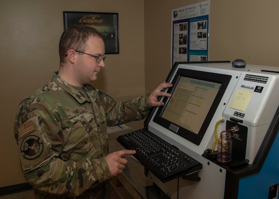 U.S. Air Force Staff Sgt. Kurt Hatch, 92nd Logistics Readiness Squadron assistant noncommissioned officer in charge, evaluates the results of transmission fluid analyzed by the Micro Lab 40 Series at Fairchild Air Force Base, Washington, Nov. 4, 2019. The oil analysis takes about five minutes per sample and provides data that technicians use to see if the oil needs to be changed or if there are indicators of future damage or component failure. (U.S. Air Force photo by Airman Anneliese Kaiser)