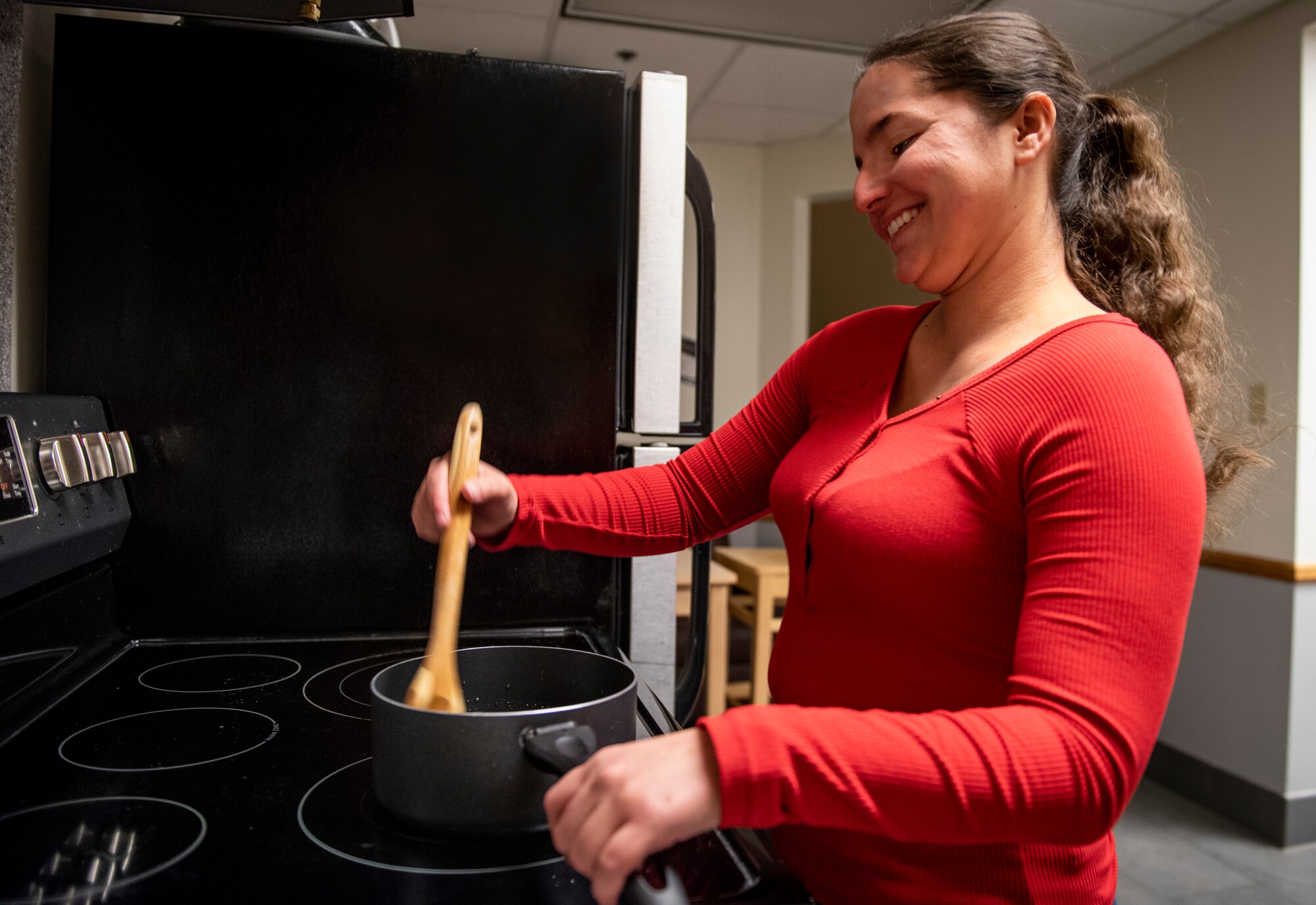 Airman 1st Class Katie Naquin, 50th Force Support Squadron customer service journeyman, cooks in the Layne Hall dayroom at Peterson Air Force Base, Colorado, Nov. 12, 2019. Naquin plans to cook stuffing for a meal with friends this Thanksgiving. (U.S. Air Force photo by Airman Amanda Lovelace)