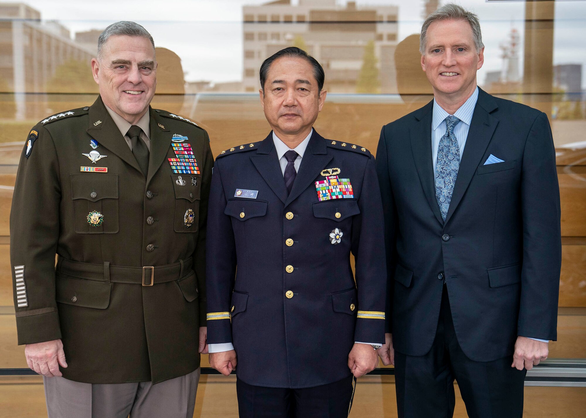 Three men pose for a photo.