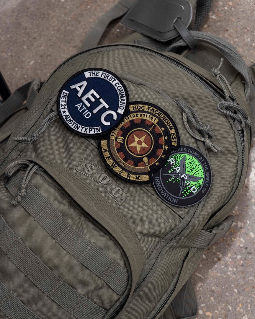 Three patches stick to Lt. Col. Jorge Manresa’s backpack at the AFWERX-Austin hub, Texas, Nov. 5, 2019. Similar to most people who work in the defense innovation space, Manresa has played many roles as part of organizations like the Air Force Installation Contracting Center, Air Education and Training Command Technology Integration Detachment, and AFWERX. Projects taken on by various Air Force units like Project NEXUS and Pilot Training Next are bolstered by collaboration between different career fields, ranks, and missions. (Air National Guard Photo by Staff Sgt. Jordyn Fetter)