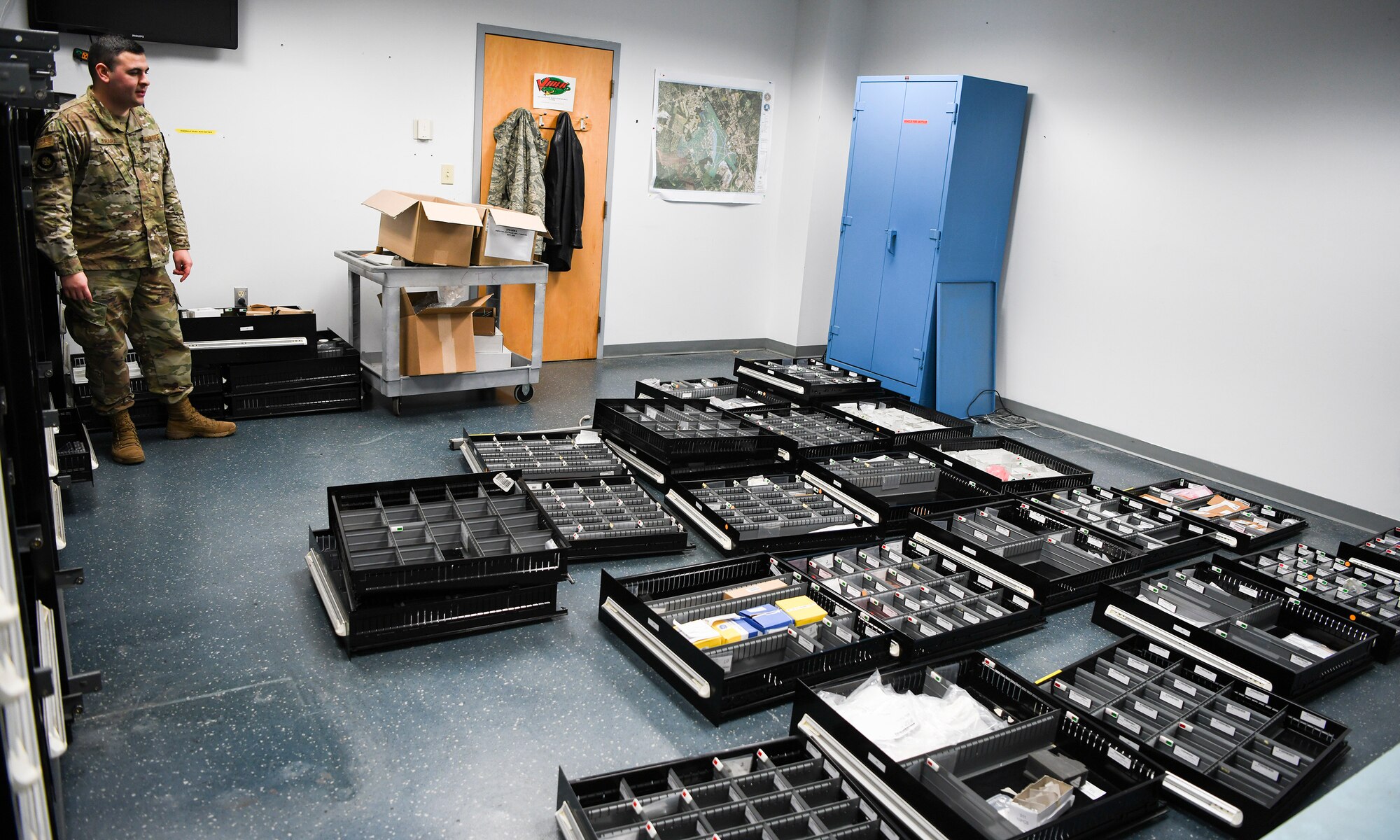 U.S. Air Force Staff Sgt. Slade Muraira, 437th Aircraft Maintenance Squadron shift leader, stands with the older tool boxes and containers that previously held the Tool Room’s extensive inventory of parts at Joint Base Charleston, S.C., Nov. 8, 2019. The new auto-mated tool crib will be able to hold the same amount of tools and maintenance parts and only take up half the space. The Airmen and NCOs of the support tool room went through a yearlong process of requesting and justifying the purchase of an automated tool crib to not only improve the quality of life for their Airmen in the shop, but also to increase their shop’s positive impact on the Joint Base Charleston flightline. The tool crib will save over 1000 man hours in labor by automatically keeping accountability of any of the tools and parts that are checked out as well as assisting in keeping a constant inventory on items in stock. The machine will also notify members when new parts should be ordered based on the supply and demand tempo of each individual part.