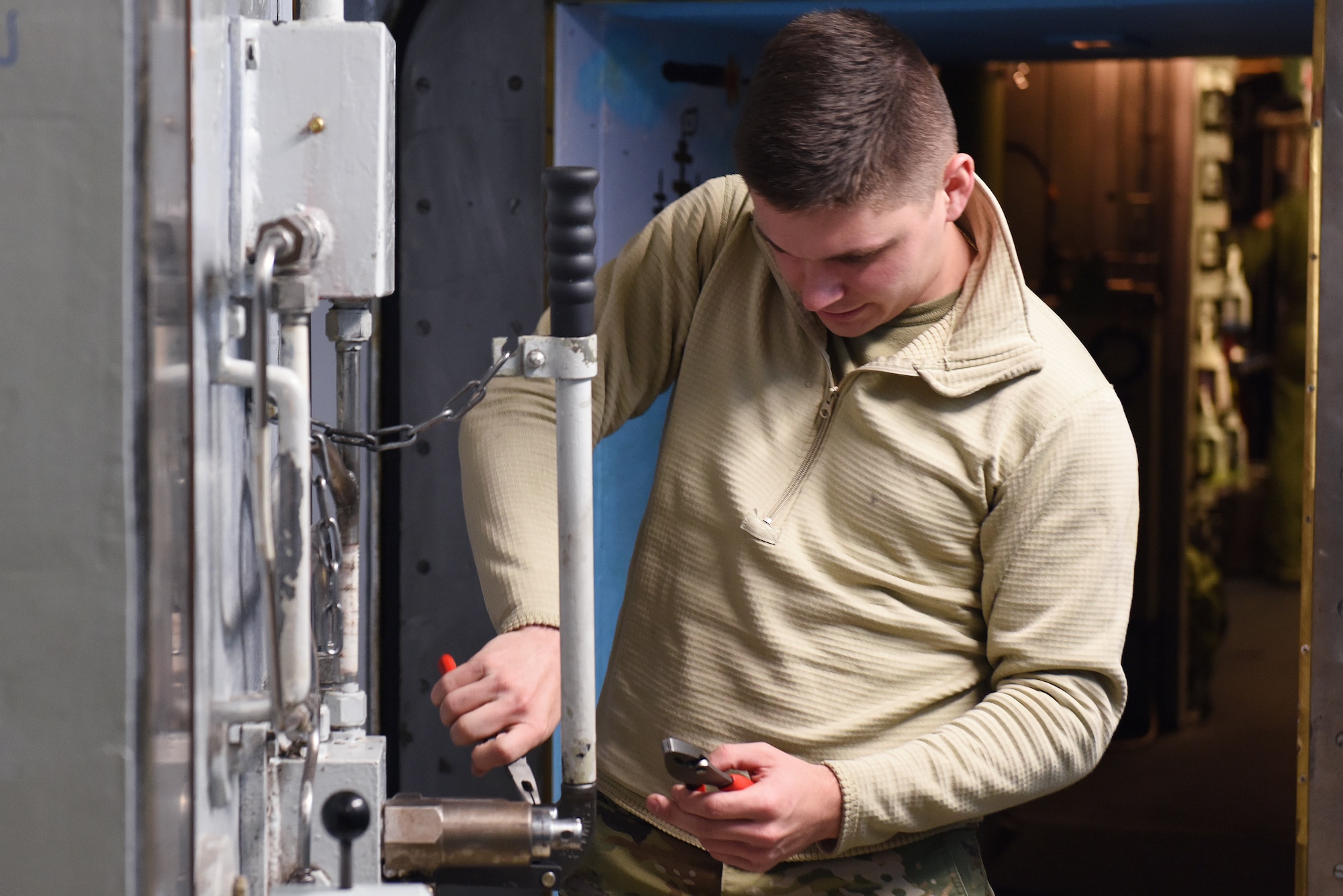 Airman 1st Class Zhane Paul, 341st Missile Maintenance Squadron survivable systems team member, performs maintenance on a launch control center blast door Oct. 29, 2019, at a Missile Alert Facility near Malmstrom Air Force Base, Mont.