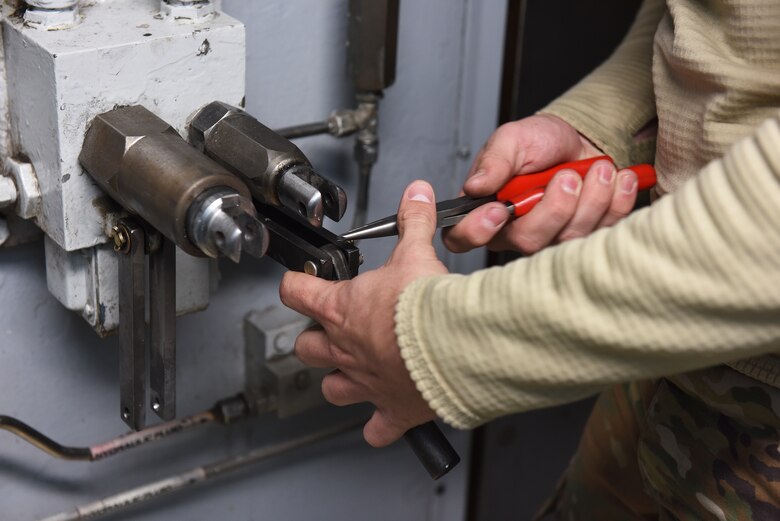 Airman 1st Class Zhane Paul, 341st Missile Maintenance Squadron survivable systems team member, performs maintenance on a launch control center blast door Oct. 29, 2019, at a Missile Alert Facility near Malmstrom Air Force Base, Mont.