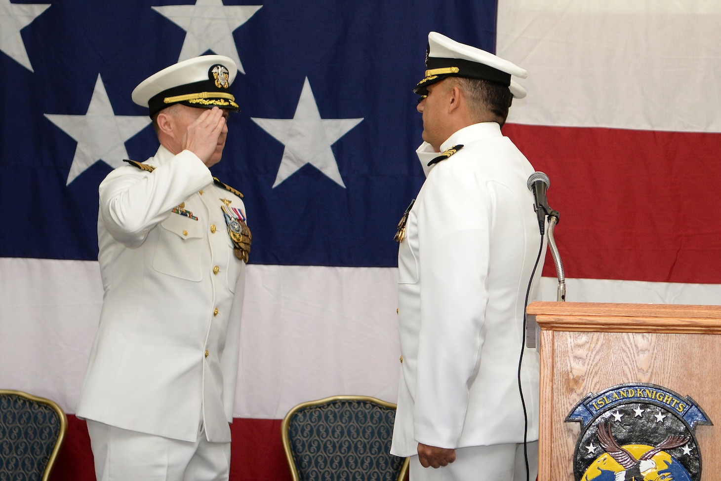 Cmdr. Christopher Carreon salutes Cmdr. Frank Loforti as he takes command during change of command ceremony for HSC-25.